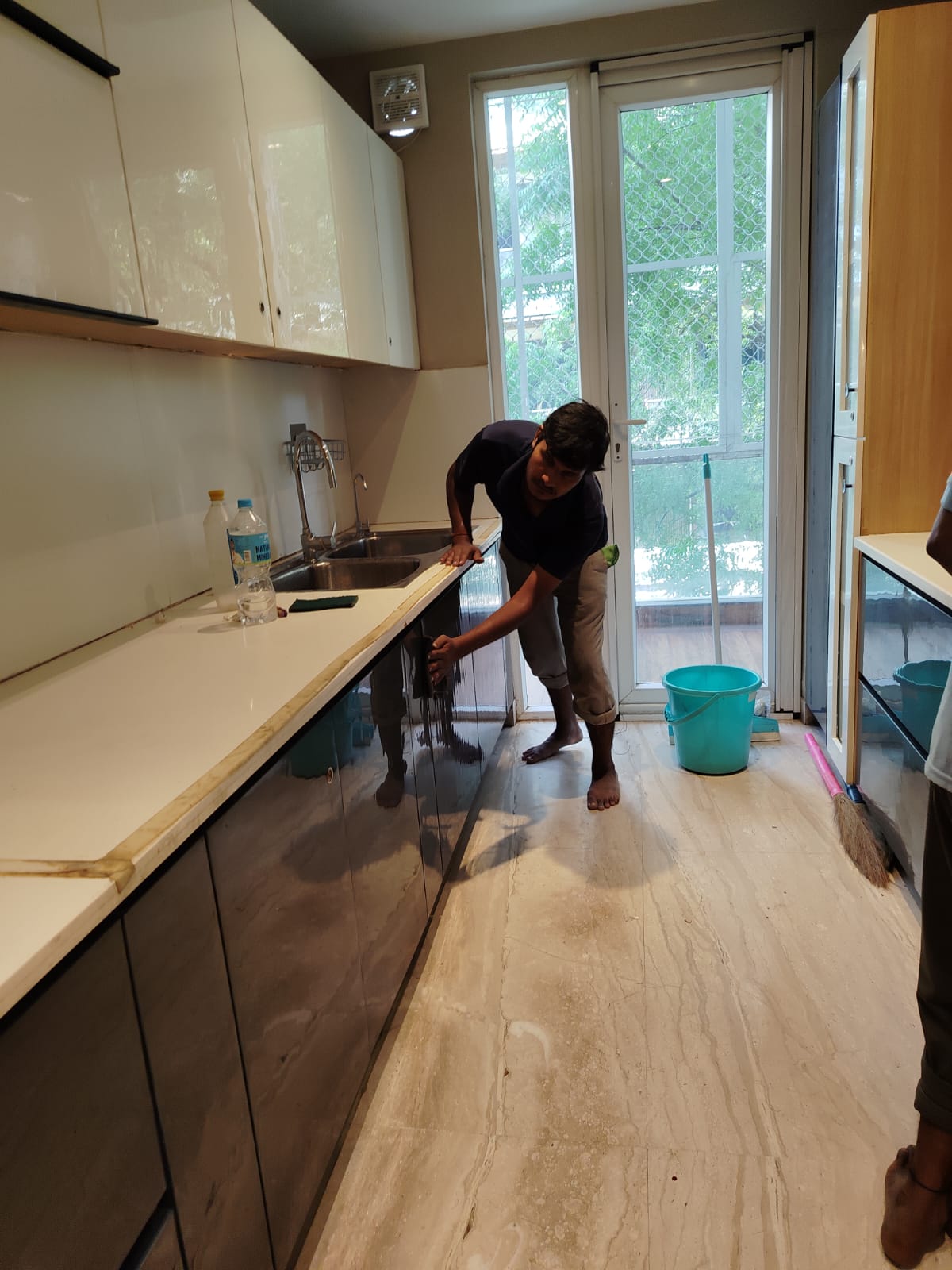 Mr. Raj Kumar at work cleaning a kitchen